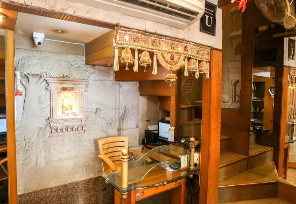 The shop counter with a carved stone wall and a small shrine